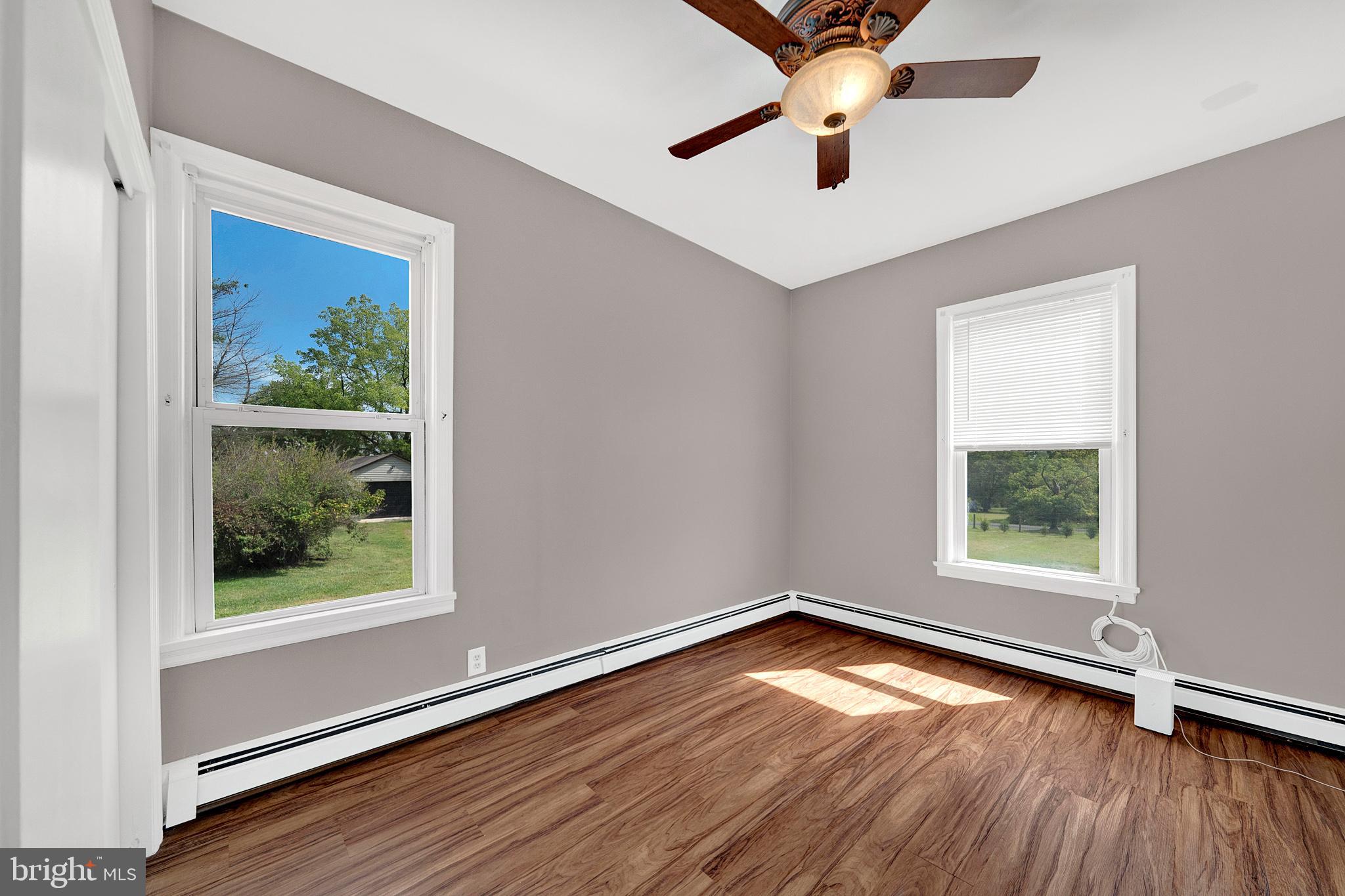 145 Hopewell - Wertsville Road Hopewell, NJ 08525 - Photo 21 of 39 an empty room with wooden floor chandelier fan and windows