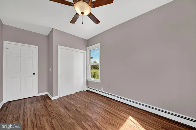 a view of room with hardwood floor and window
