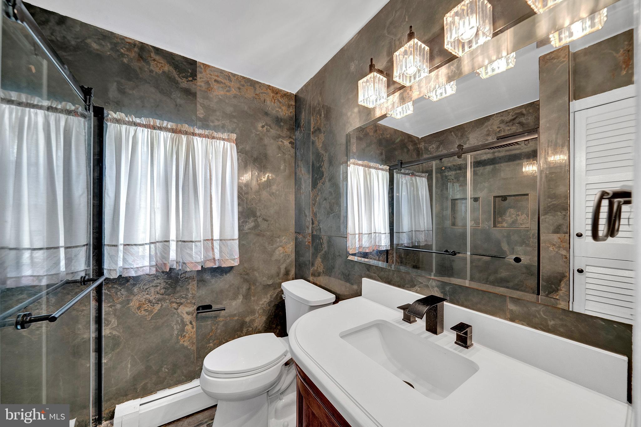 145 Hopewell - Wertsville Road Hopewell, NJ 08525 - Photo 23 of 39 a bathroom with a sink a toilet and a mirror