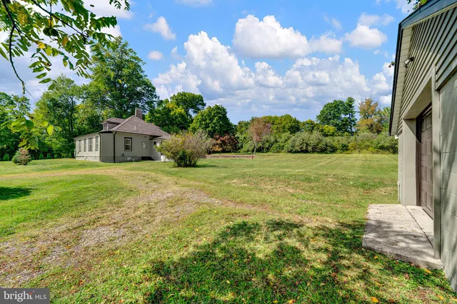 a house view with swimming pool and garden space