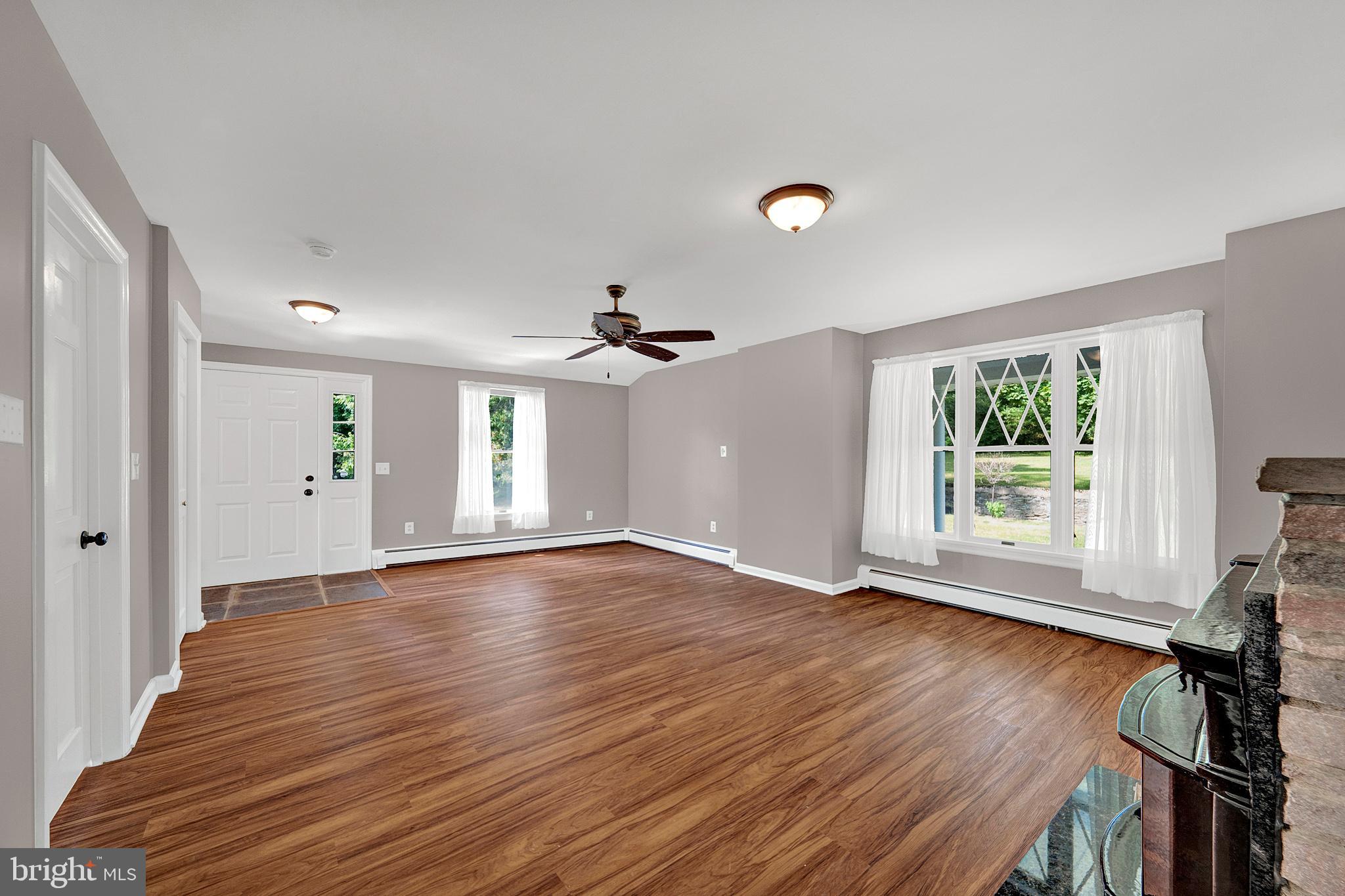 145 Hopewell - Wertsville Road Hopewell, NJ 08525 - Photo 4 of 39 a view of an empty room with wooden floor and a window