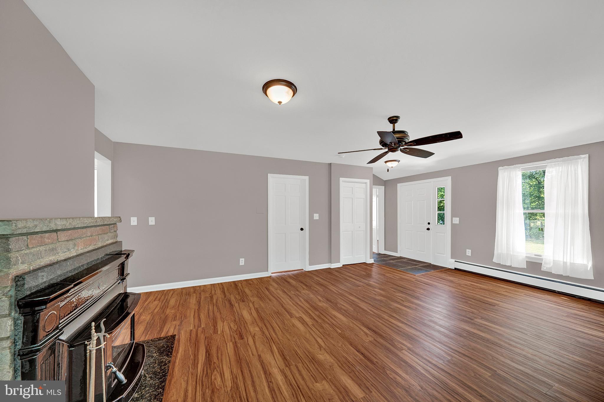 145 Hopewell - Wertsville Road Hopewell, NJ 08525 - Photo 5 of 39 a view of an empty room with window and wooden floor
