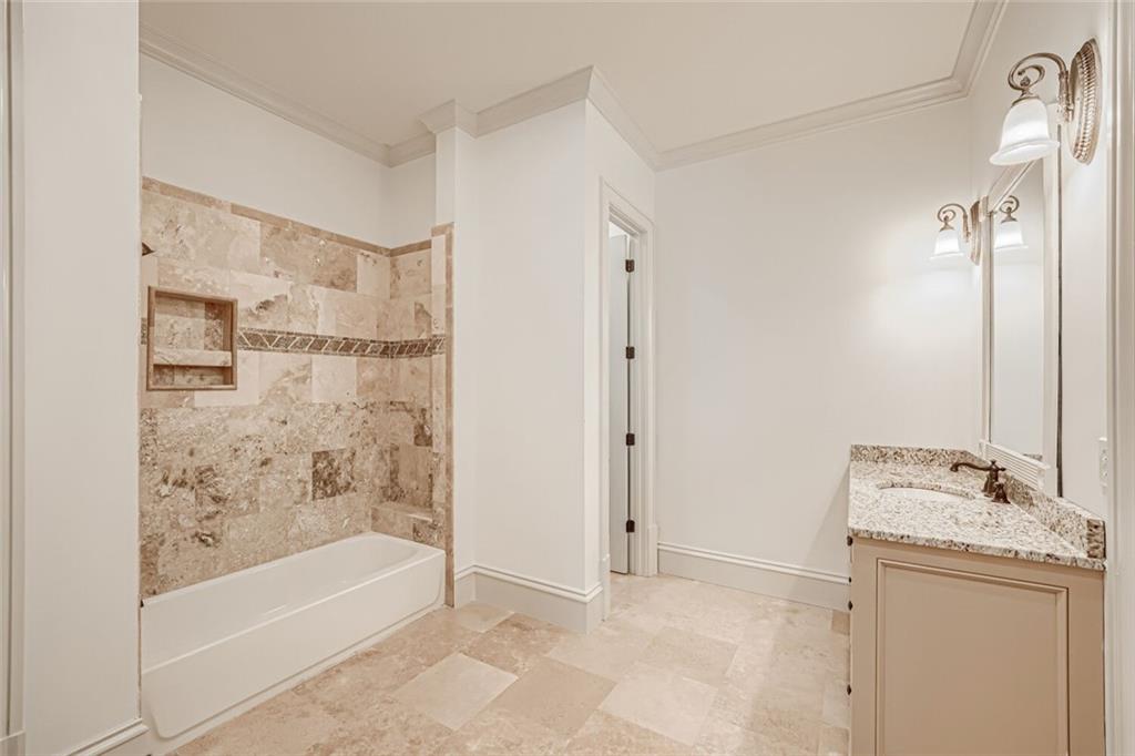 7965 Robin Road Cumming, GA 30041 - Photo 43 of 64 a bathroom with a bathtub and shower