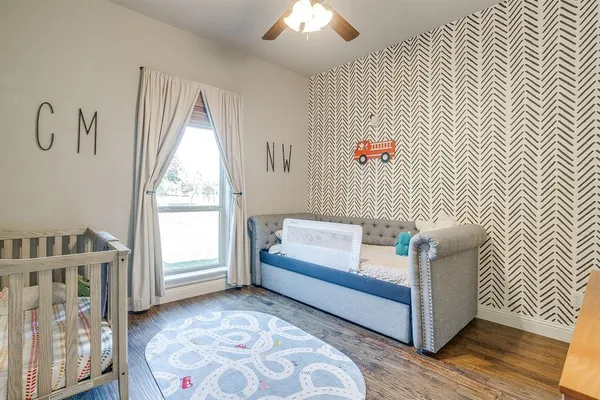 a bedroom with furniture and a window