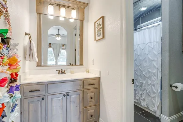 a bathroom with a sink vanity and a mirror