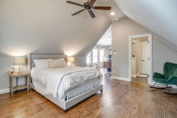 a bedroom with a bed and a mirror