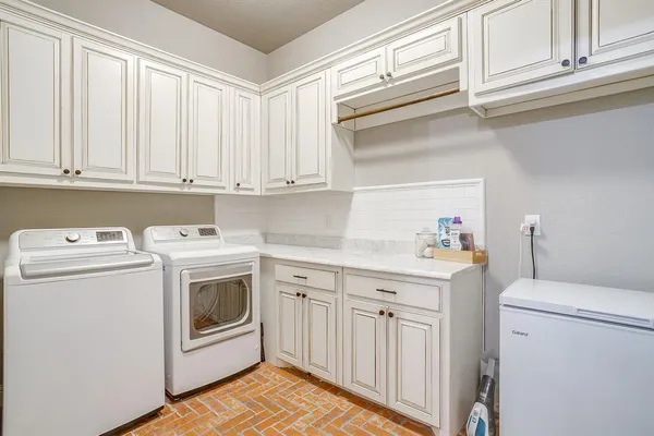 a utility room with sink dryer and washer