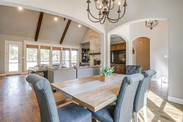 a view of a dining room with furniture wooden floor and chandelier