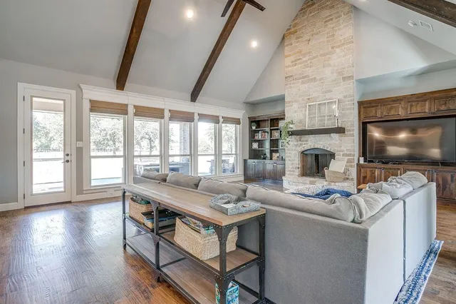 a living room with furniture a flat screen tv and a fireplace