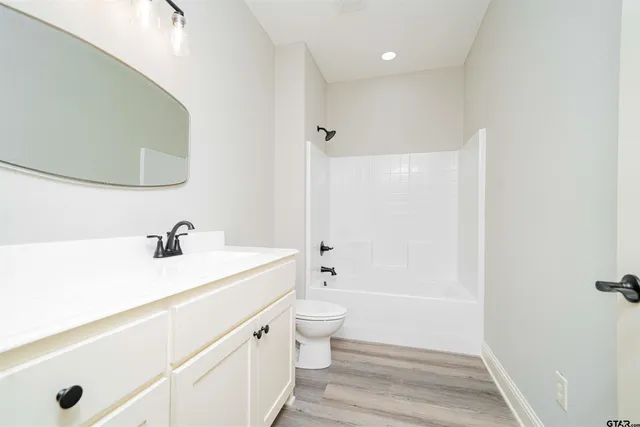 an empty room with a window and a ceiling fan