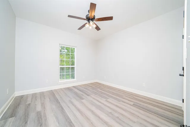 an empty room with windows and closet