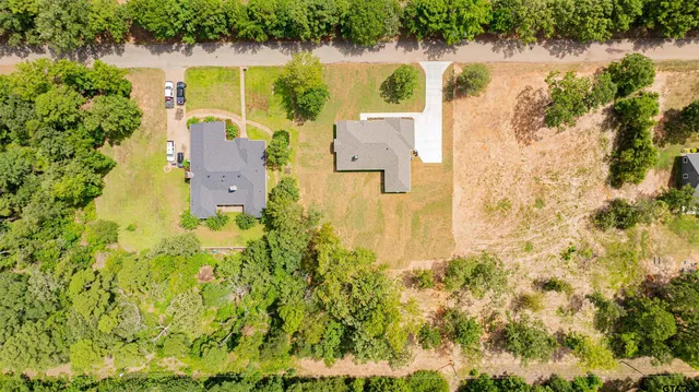 an aerial view of residential houses with yard