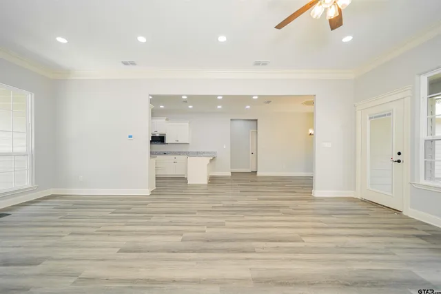 a view of empty room with wooden floor