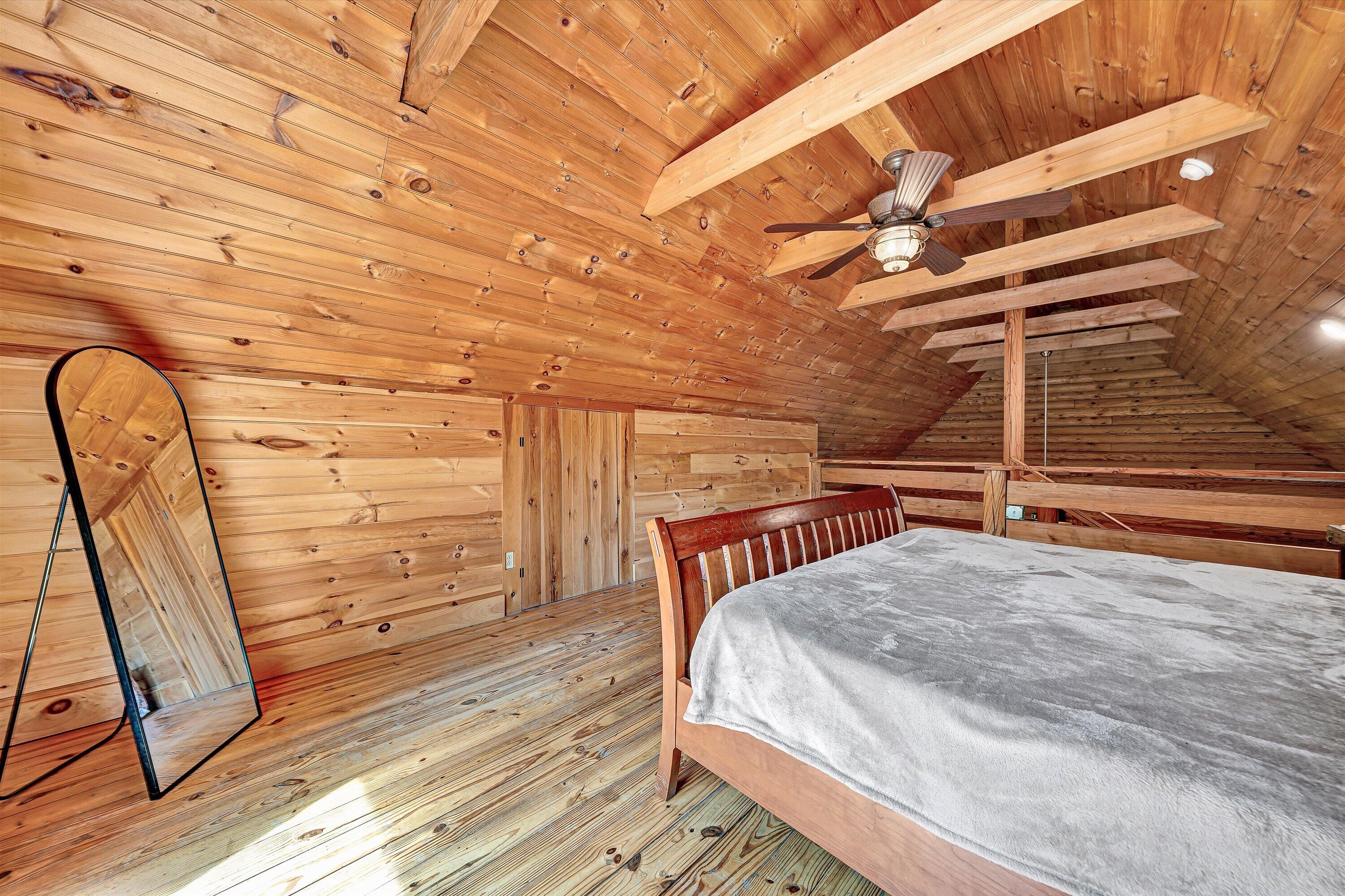 6211 Hillcrest Road Salem, VA 24153 - Photo 18 of 36 a bedroom with a bed a desk and chair with wooden floor