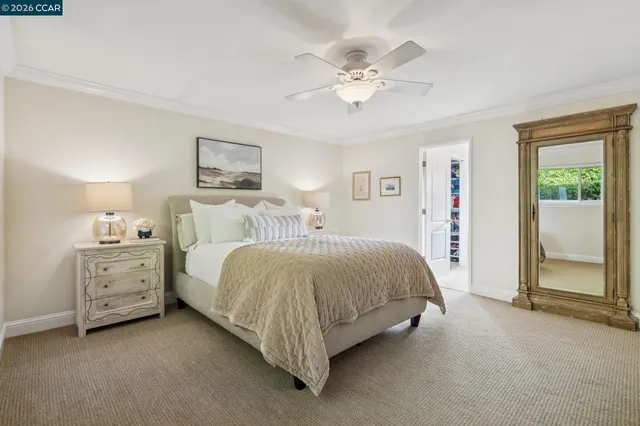 a spacious bedroom with a bed and a chandelier