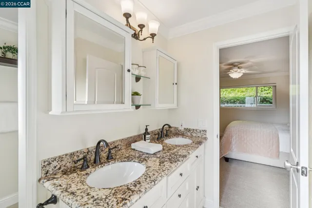 a bathroom with a granite countertop sink a mirror and a vanity