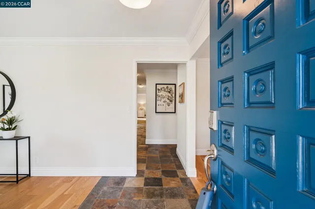 a view of a dining room with furniture wooden floor and a chandelier