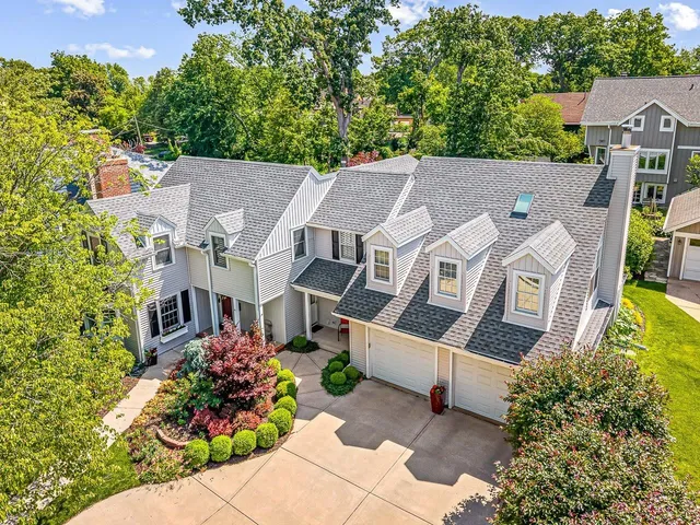 an aerial view of multiple houses with a yard