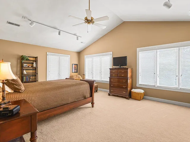a living room with furniture a rug and a book shelf