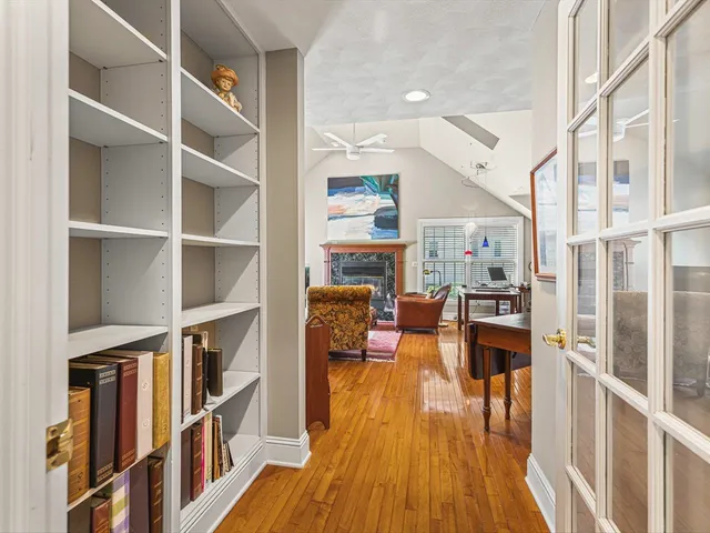 a view of a patio with dining table and chairs with wooden floor and fence