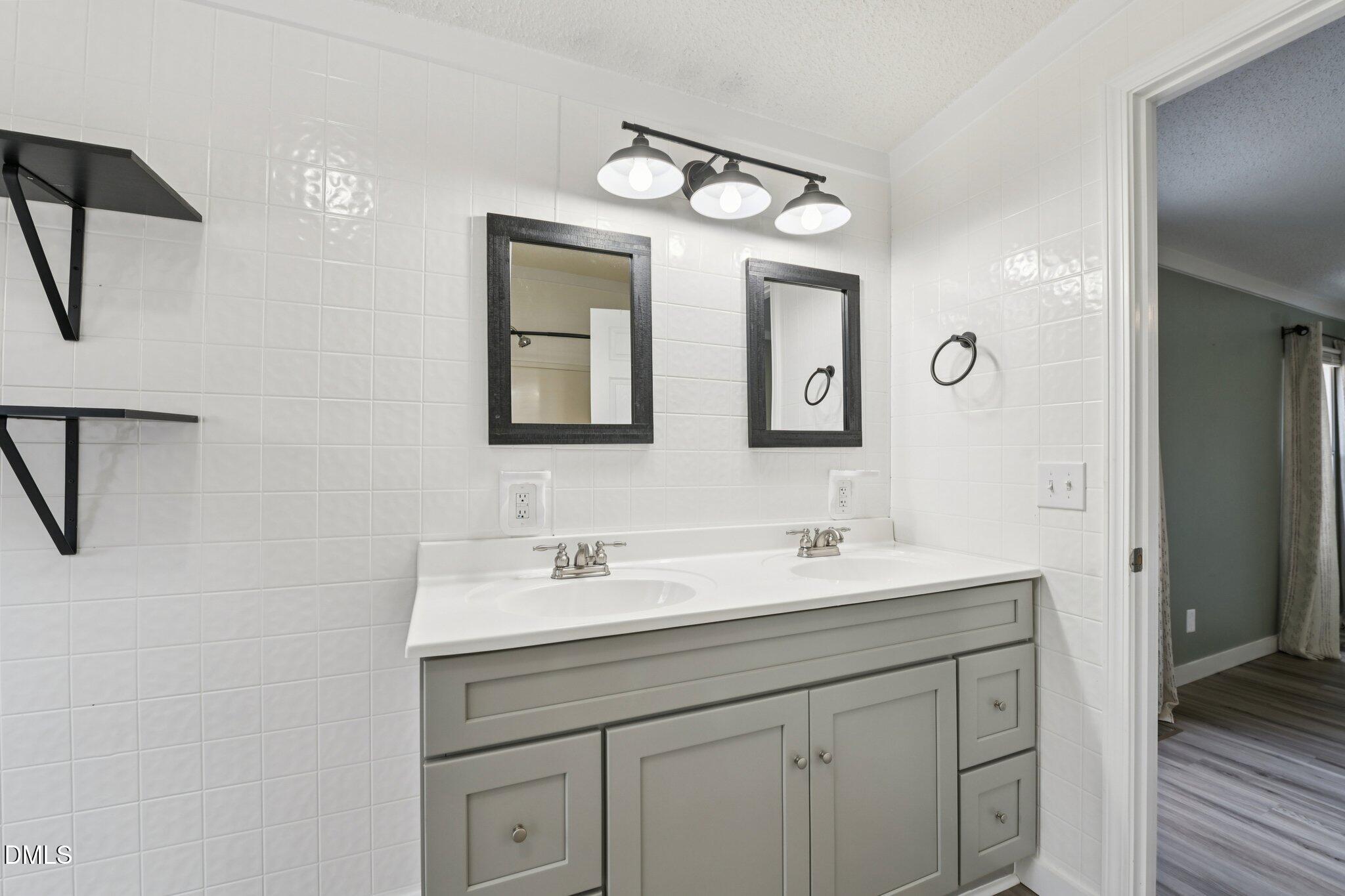 5393 Frazier Road Spring Hope, NC 27882 - Photo 17 of 23 a bathroom with 2 sink and a mirror