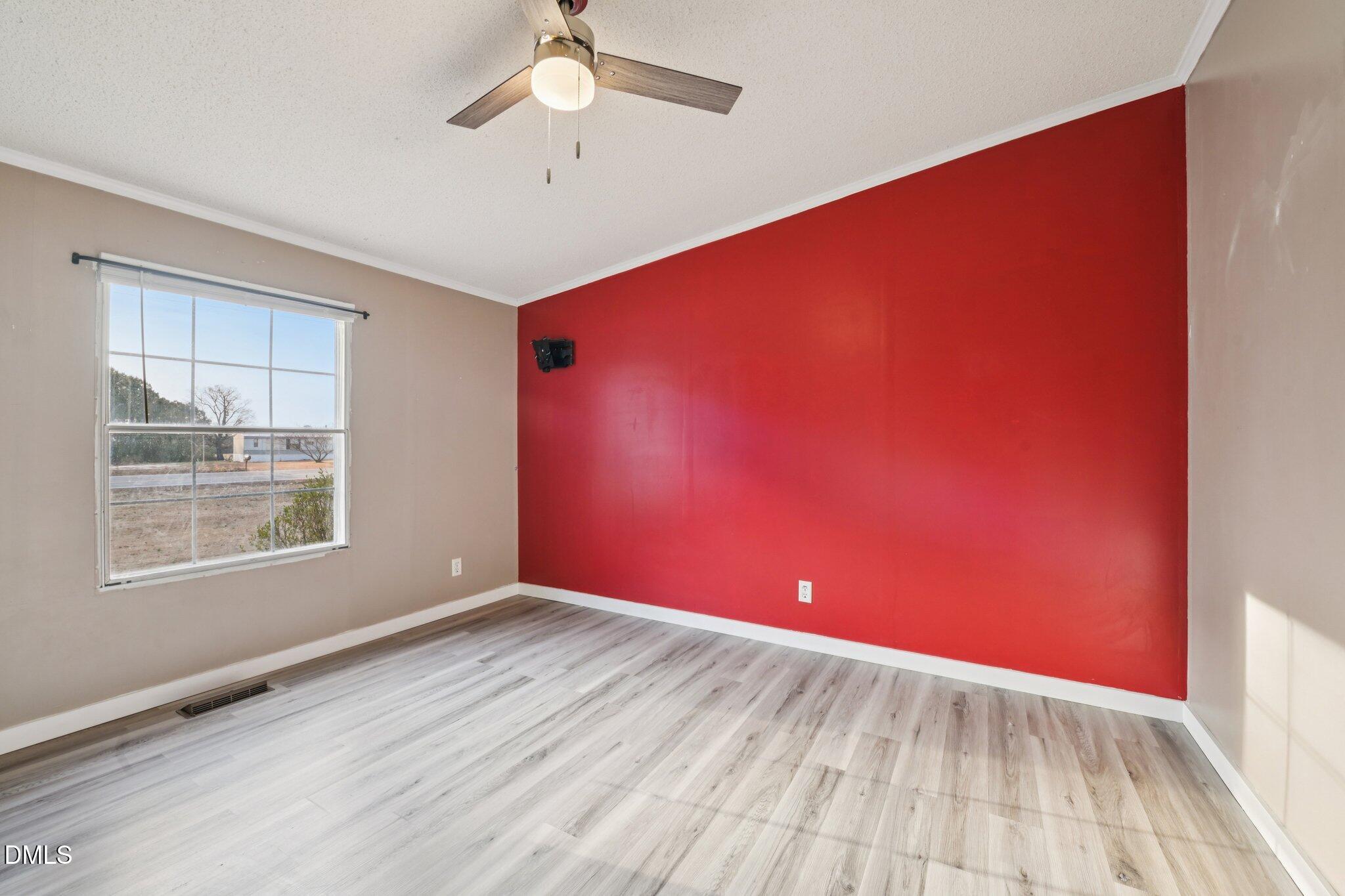 5393 Frazier Road Spring Hope, NC 27882 - Photo 19 of 23 an empty room with wooden floor and windows