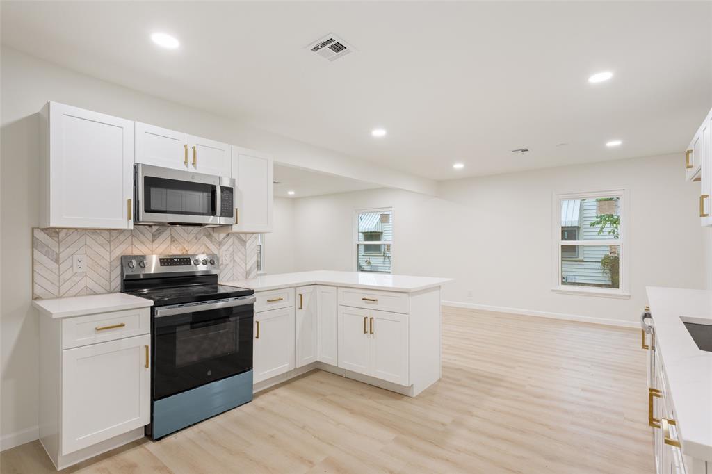 1029 North 45th Street Waco, TX 76710 - Photo 13 of 35 a kitchen with a sink stove and microwave