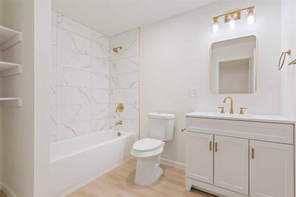 1029 North 45th Street Waco, TX 76710 - Photo 16 of 35 a bathroom with a bathtub shower sink mirror and toilet