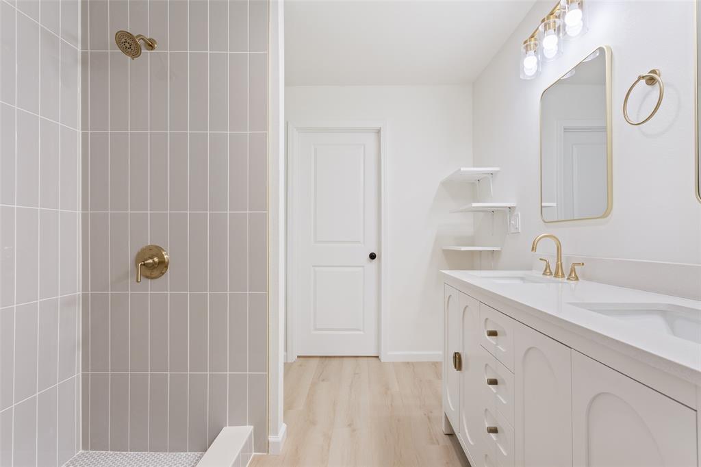 1029 North 45th Street Waco, TX 76710 - Photo 18 of 35 a bathroom with a sink vanity granite tub shower and a mirror