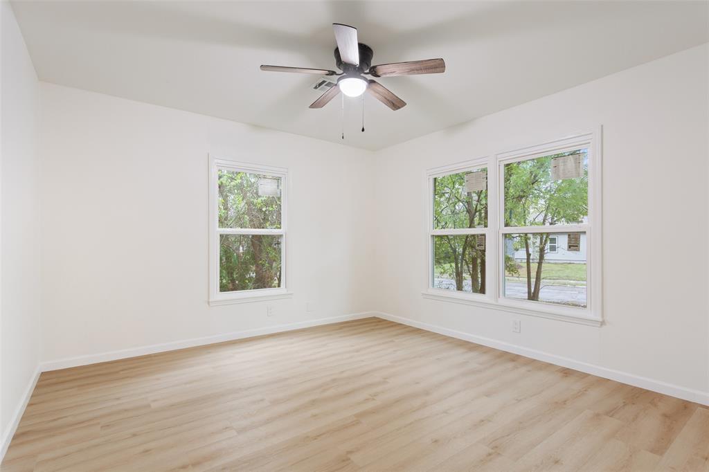 1029 North 45th Street Waco, TX 76710 - Photo 26 of 35 a view of an empty room with wooden floor and a window