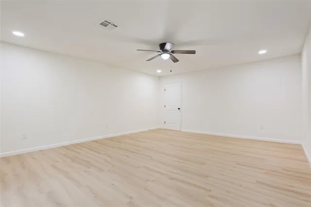 a view of an empty room with a ceiling fan