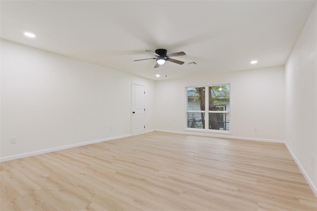1029 North 45th Street Waco, TX 76710 - Photo 30 of 35 a view of an empty room with a window and wooden floor