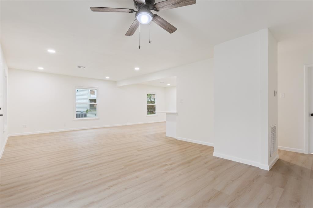 1029 North 45th Street Waco, TX 76710 - Photo 8 of 35 an empty room with wooden floor fan and windows