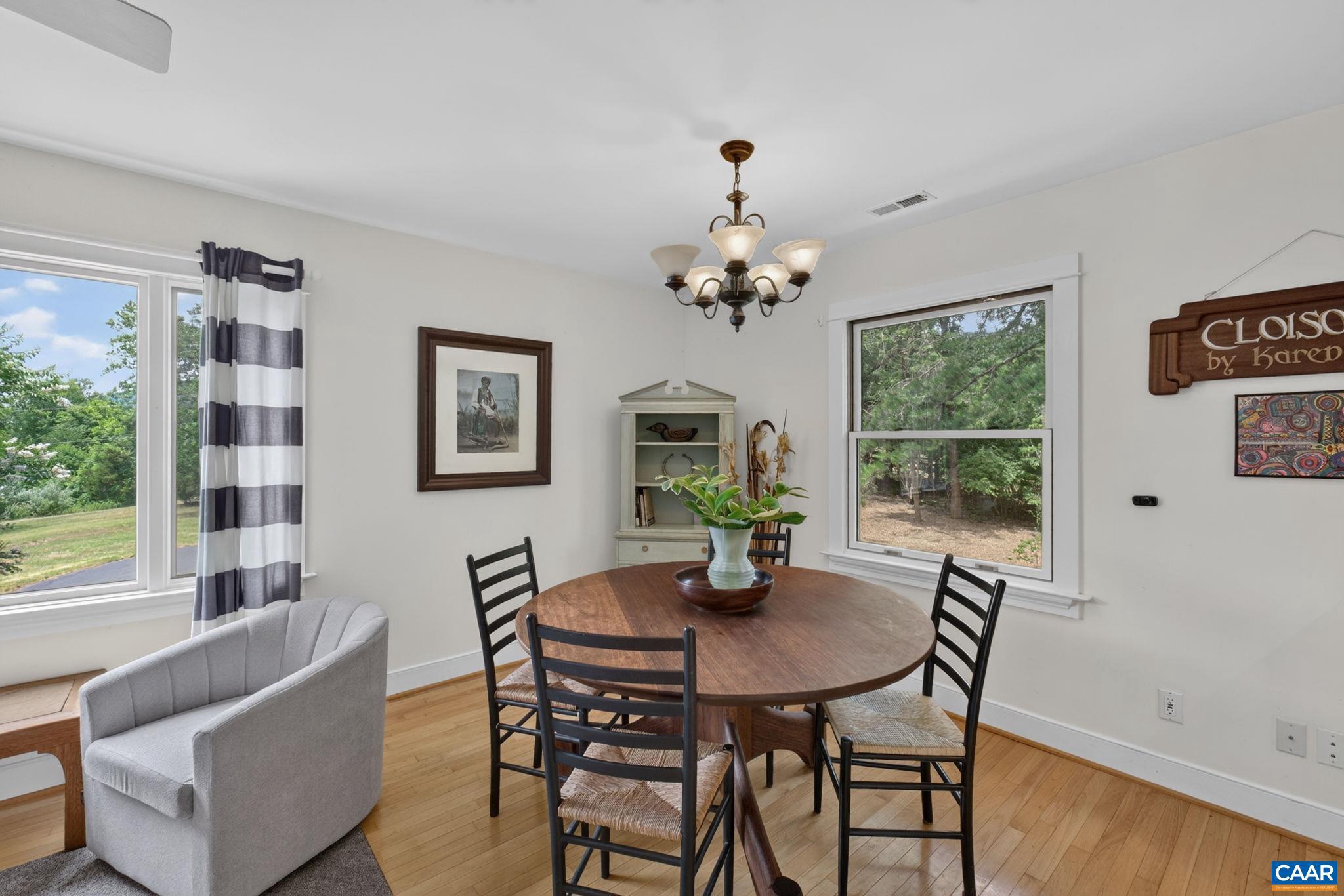 6285 Jarmans Gap Road Crozet, VA 22932 - Photo 30 of 65 a dining room with furniture a large window and wooden floor