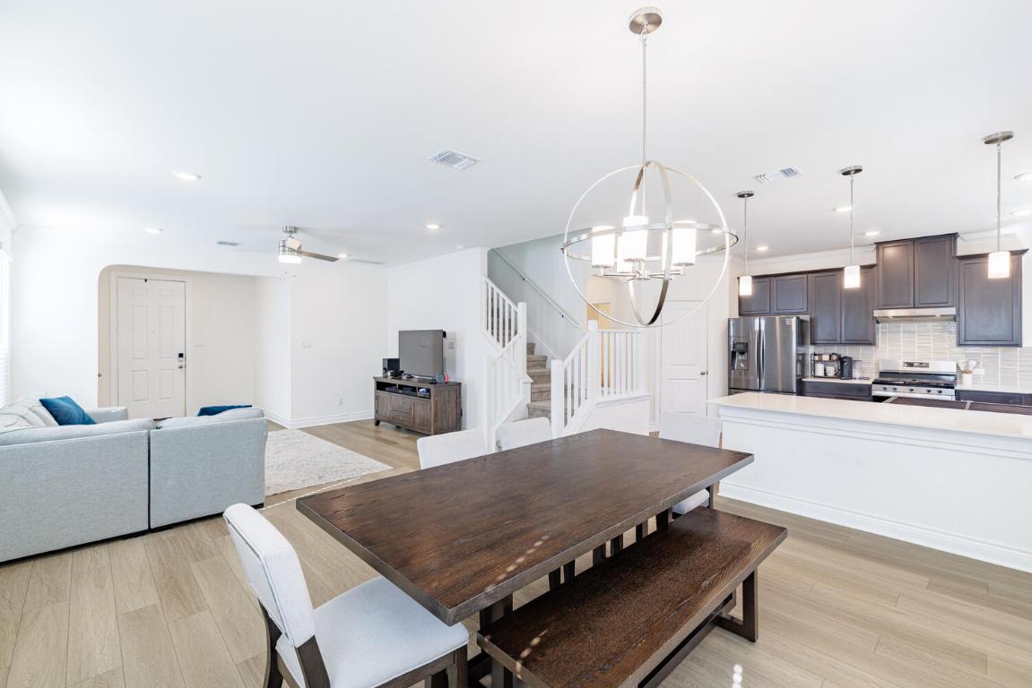 4641 Alfano Loop Round Rock, TX 78665 - Photo 13 of 32 a living room with kitchen island furniture and a chandelier