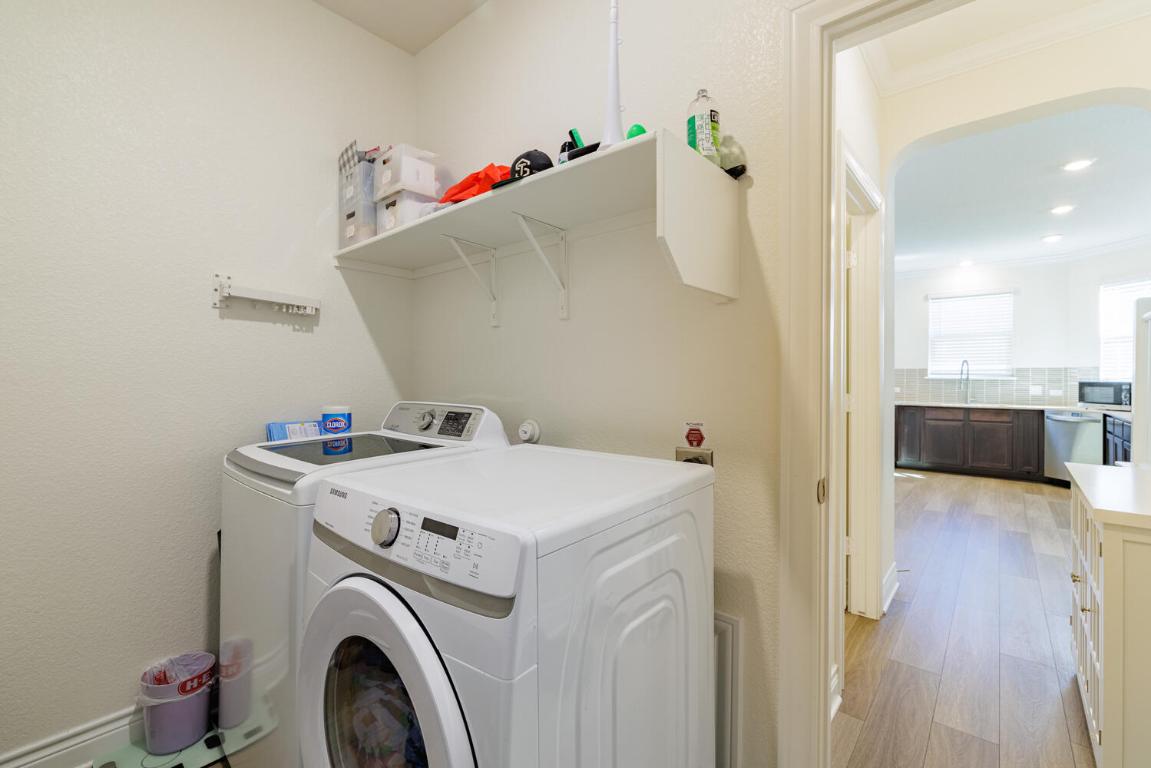 4641 Alfano Loop Round Rock, TX 78665 - Photo 16 of 32 a view of washer and dryer with kitchen in the background
