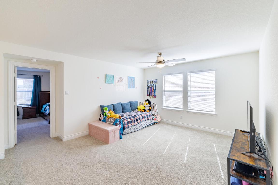 4641 Alfano Loop Round Rock, TX 78665 - Photo 18 of 32 a living room with furniture and a flat screen tv