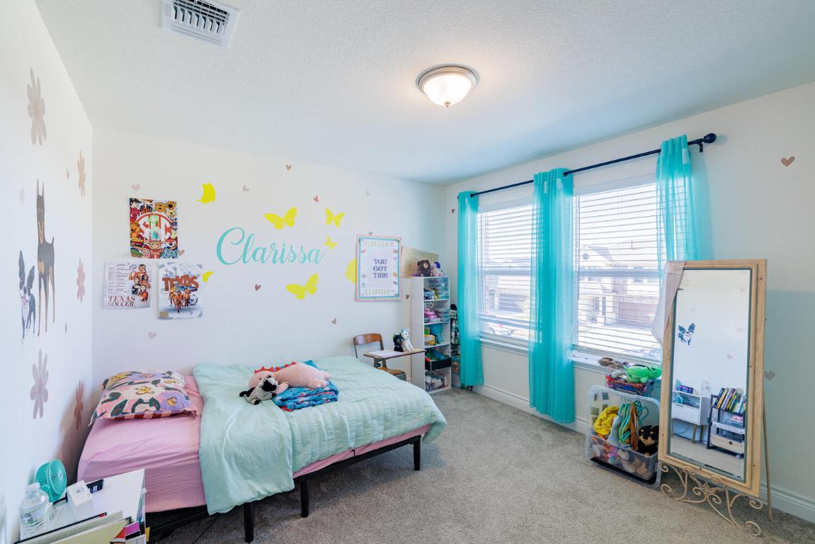 4641 Alfano Loop Round Rock, TX 78665 - Photo 19 of 32 a bedroom with toys and a couch