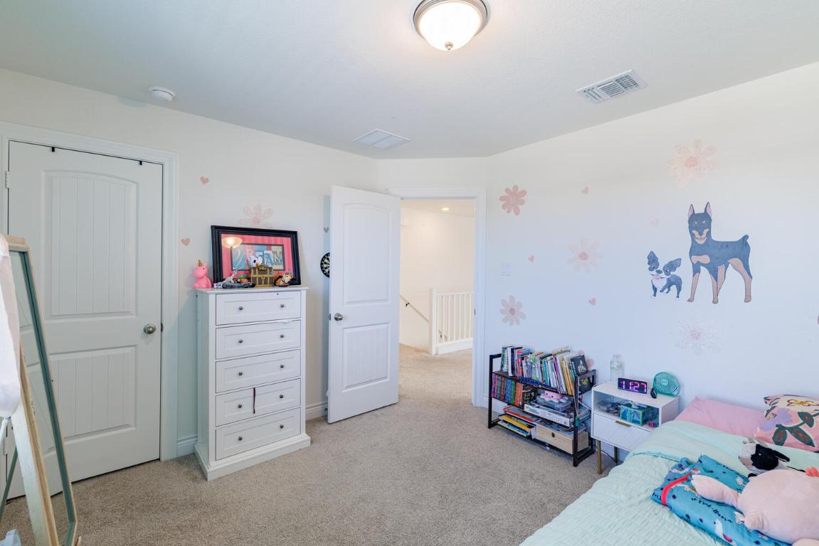 4641 Alfano Loop Round Rock, TX 78665 - Photo 20 of 32 a bedroom with furniture and a baby crib