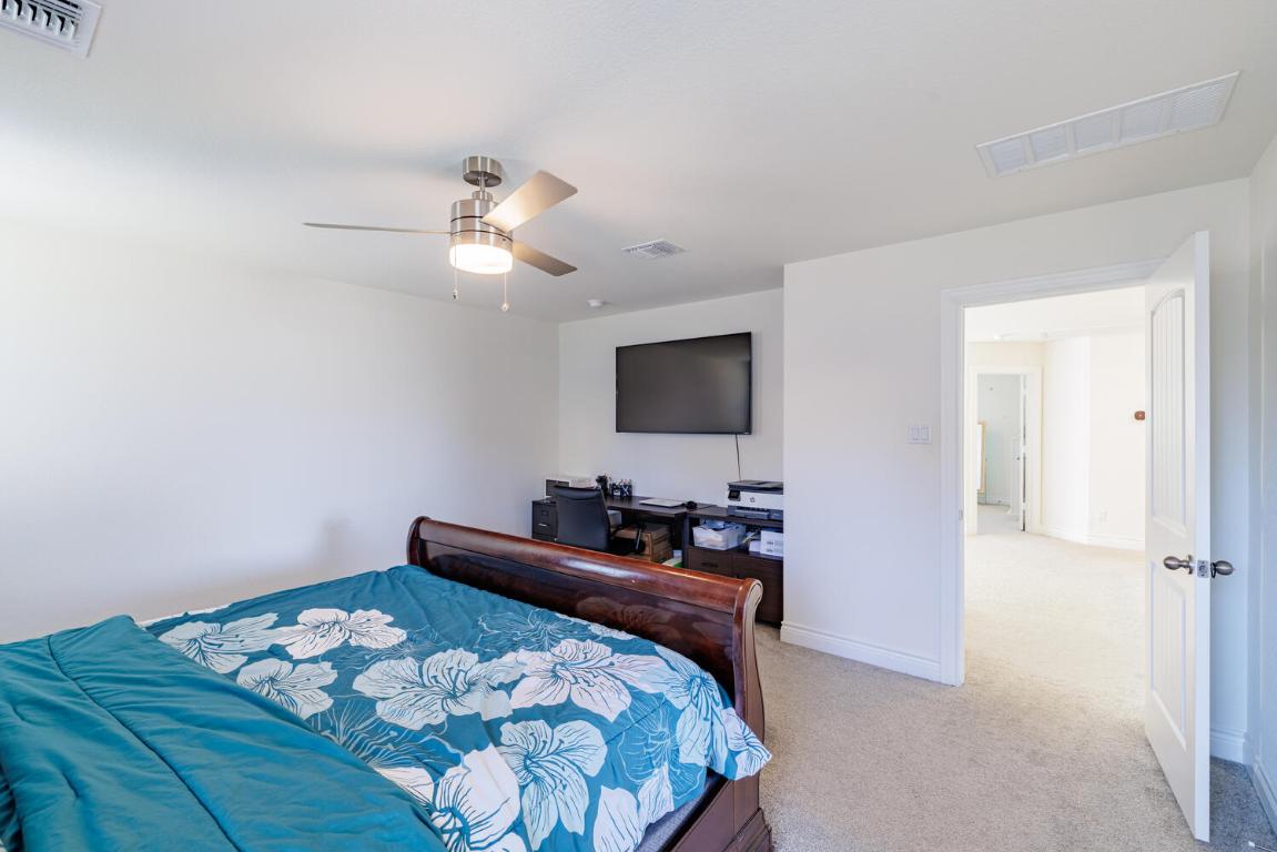 4641 Alfano Loop Round Rock, TX 78665 - Photo 21 of 32 a bedroom with bed dresser and flat screen tv