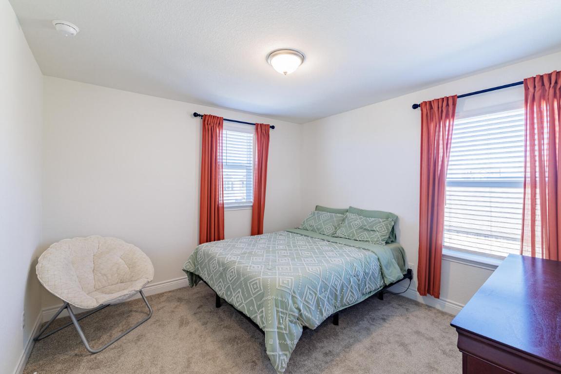 4641 Alfano Loop Round Rock, TX 78665 - Photo 26 of 32 a bedroom with a bed and a table in it
