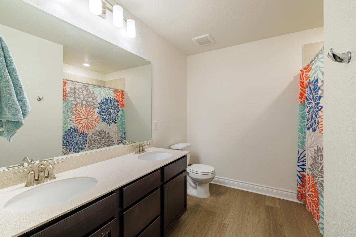 4641 Alfano Loop Round Rock, TX 78665 - Photo 27 of 32 a bathroom with a sink and a mirror