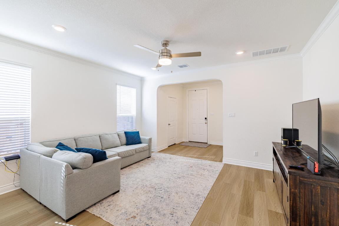 4641 Alfano Loop Round Rock, TX 78665 - Photo 6 of 32 a living room with furniture and a flat screen tv