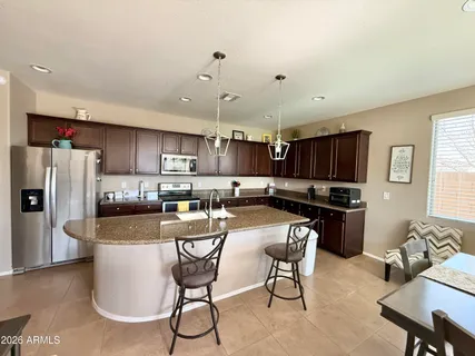 a view of a hallway with wooden floor and a living room