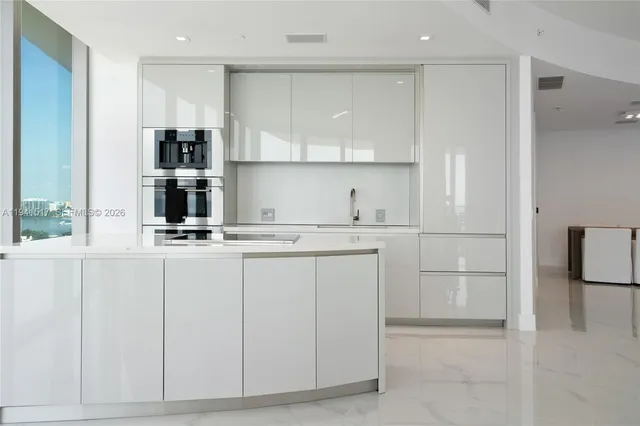 a kitchen with granite countertop a cabinets and stainless steel appliances