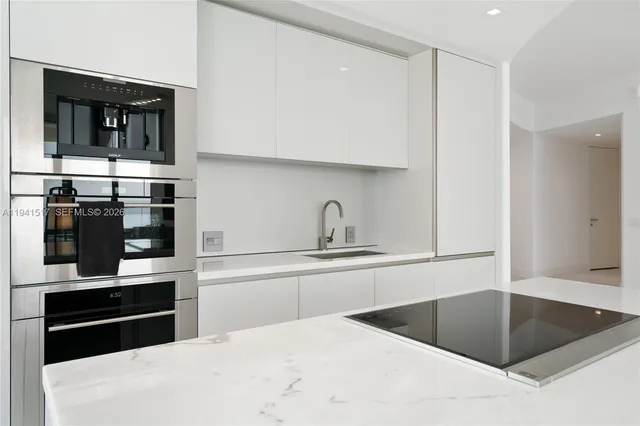 a kitchen with stainless steel appliances a refrigerator and cabinets
