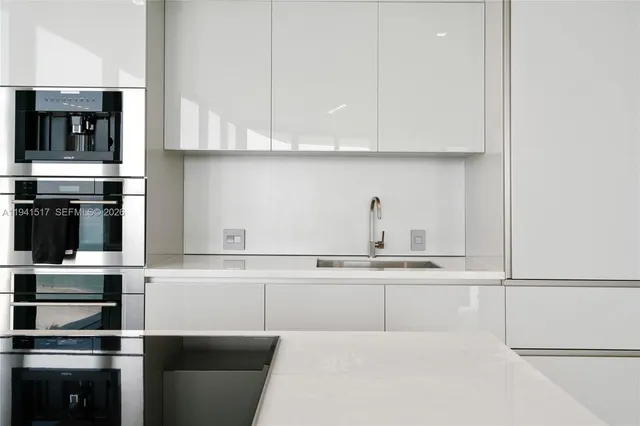 a large bed sitting in a bedroom next to a large window