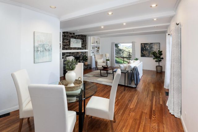 a living room with furniture fireplace and wooden floor