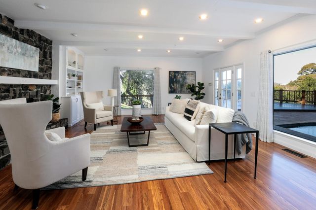 a living room with fireplace furniture and a wooden floor