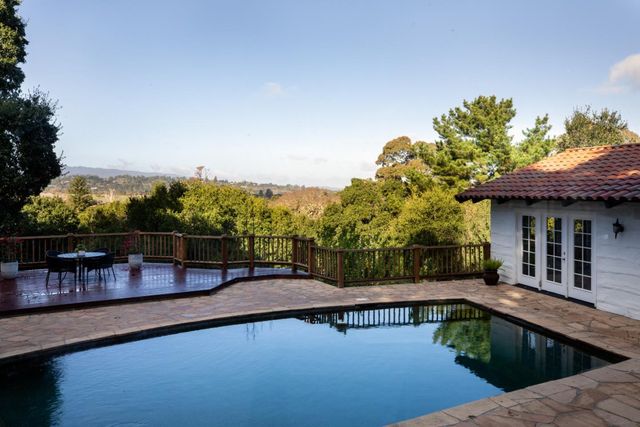 a view of a swimming pool with a lounge chair